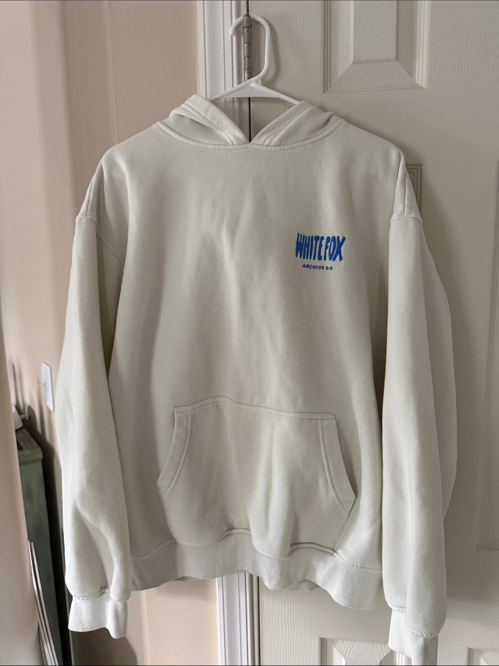 White Fox Boutique Cream Hoodie with Small Blue Logo